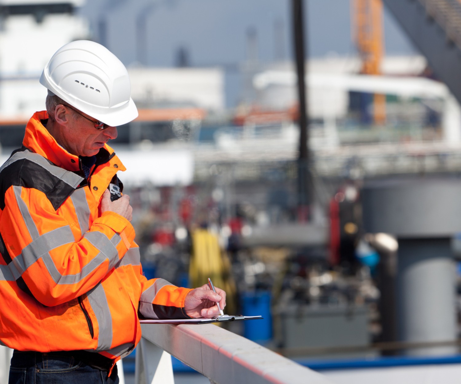 Dockworker giving instructions and writing
